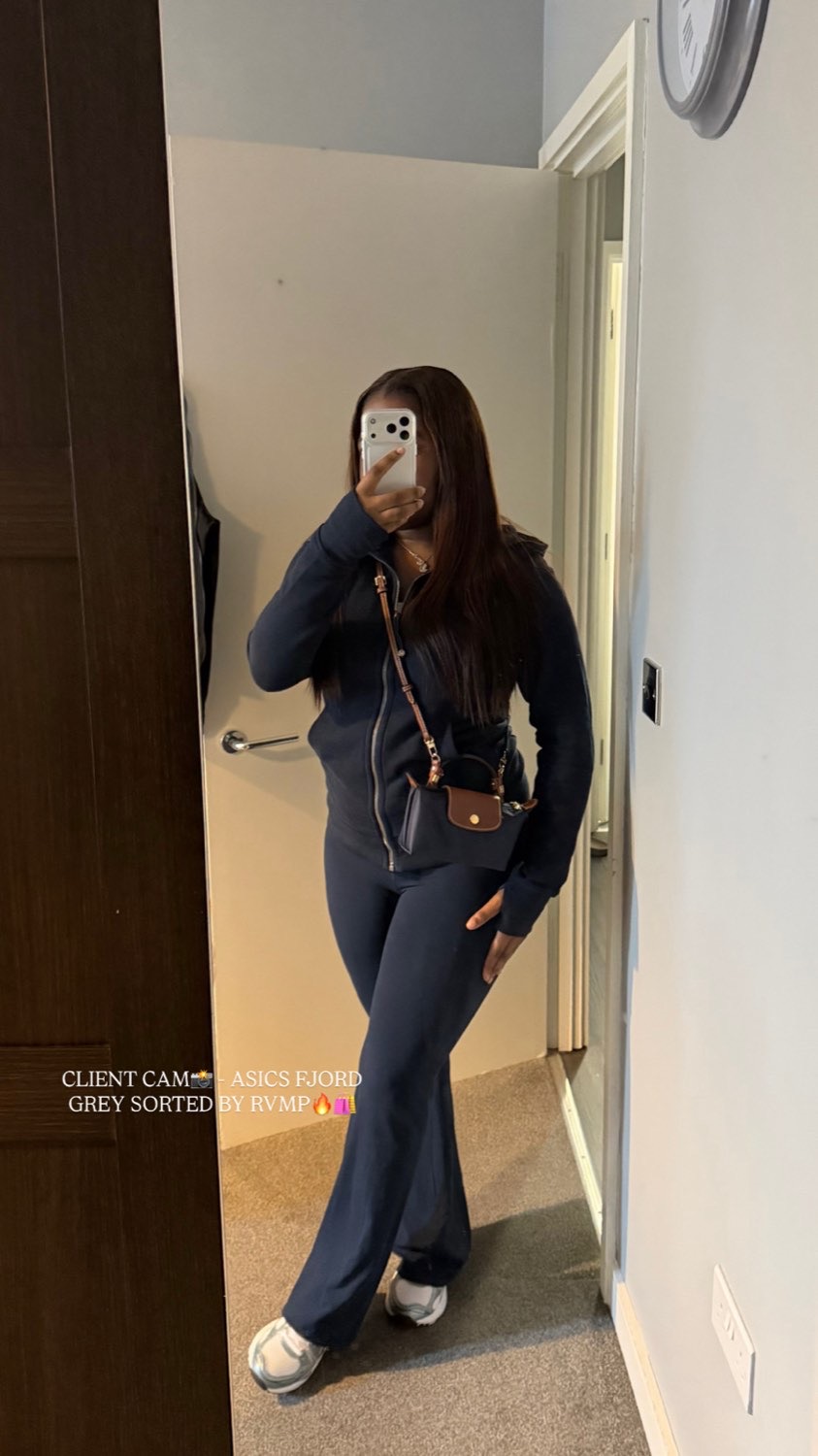 Client mirror selfie in a navy tracksuit and grey Asics