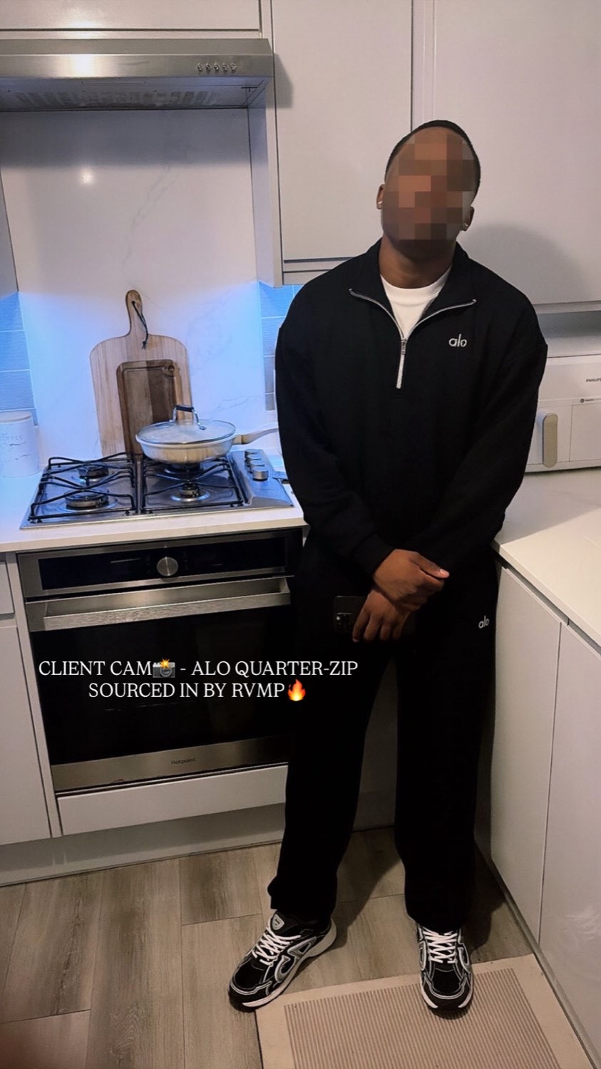 Client in a black Alo quarter-zip and joggers in a kitchen