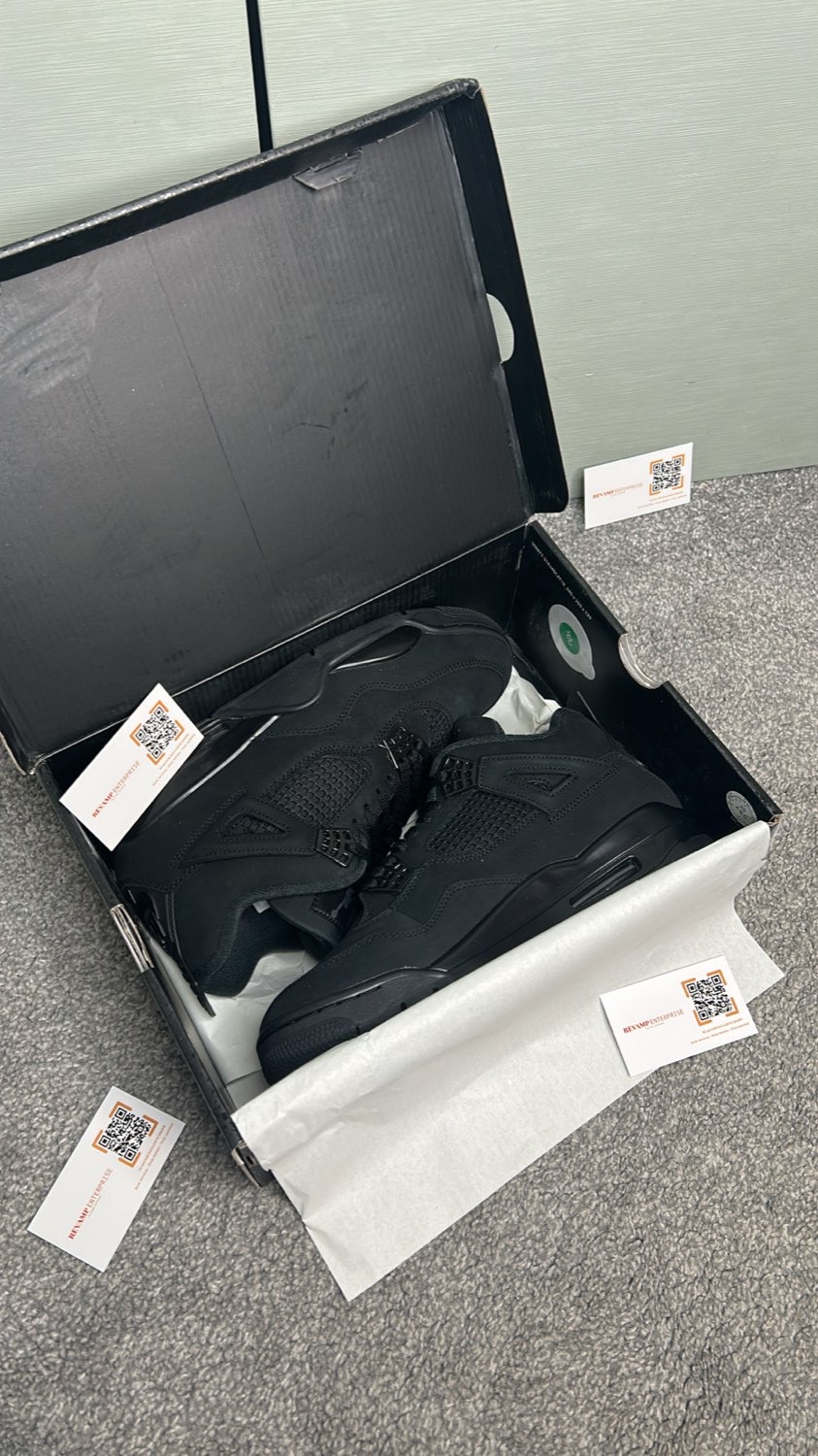Black Jordan 4 sneakers in their box