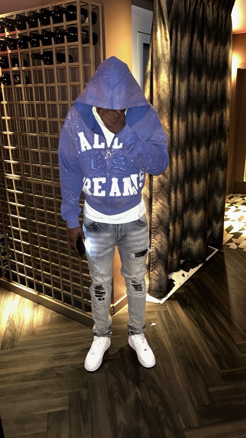 RVMP client in a blue Valley Dreams zip hoodie, ripped grey jeans and white trainers