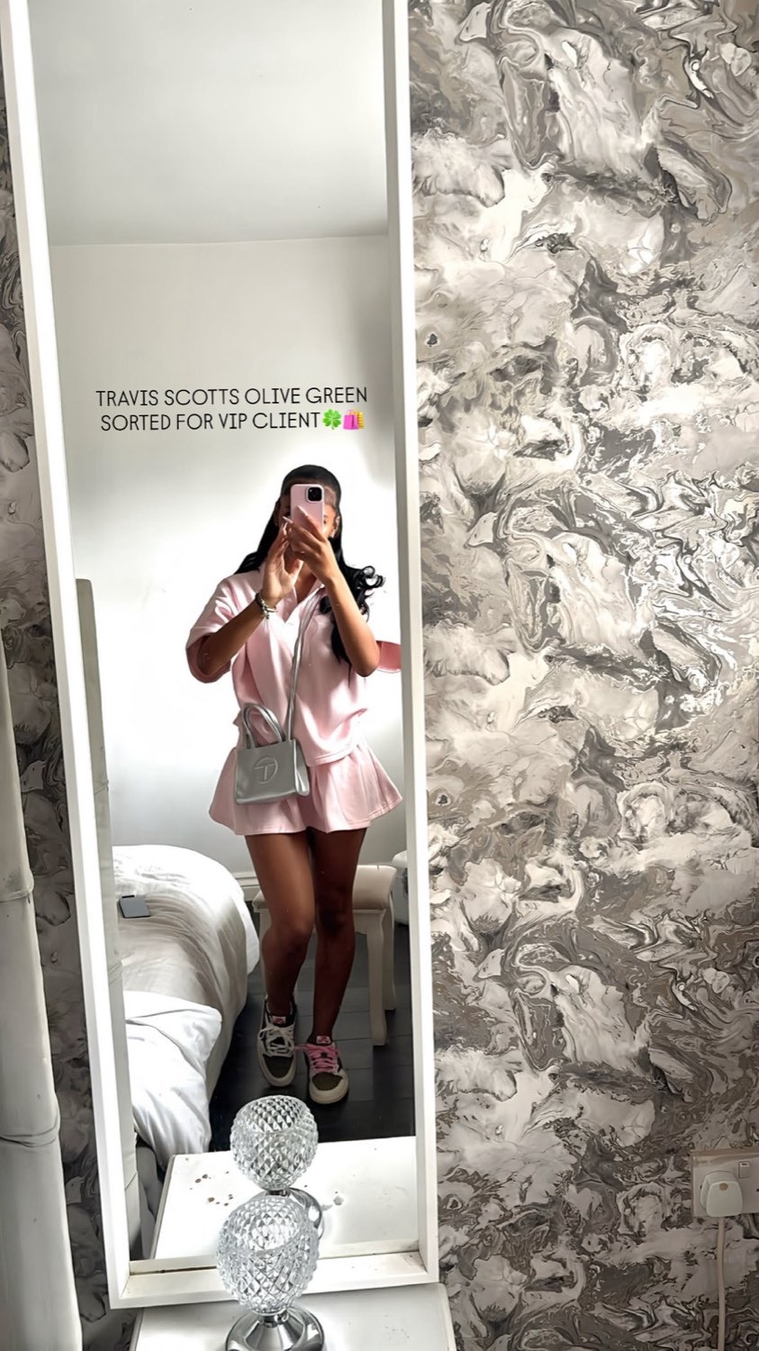 Client mirror selfie in a pink outfit wearing olive Travis Scott sneakers